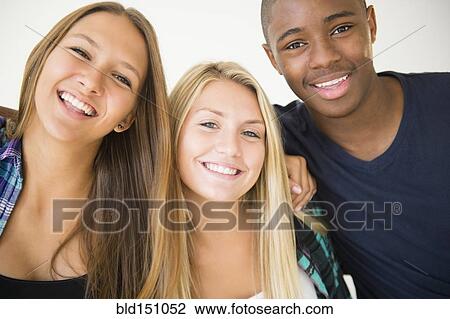 Stock Image - Teenagers hugging and smiling. Fotosearch