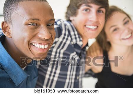 Stock Image - Teenagers hugging and smiling. Fotosearch