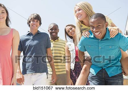 Teenagers standing together outdoors View Large Photo Image Stock Photo - Teenagers standing together outdoors. Fotosearch