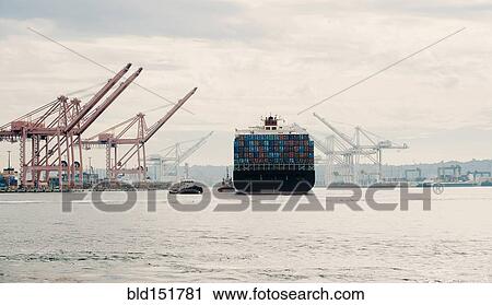 Tugboat and container ship in industrial harbor View Large Photo Image Stock Image - Tugboat and container ship in industrial harbor. Fotosearch