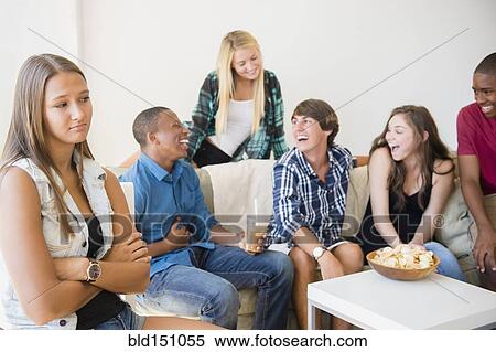 Stock Photography - Unhappy teenage girl pouting at party. Fotosearch