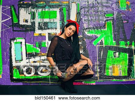 Woman posing in front of colorful graffiti wall View Large Photo Image Stock Image - Woman posing in front of colorful graffiti wall. Fotosearch