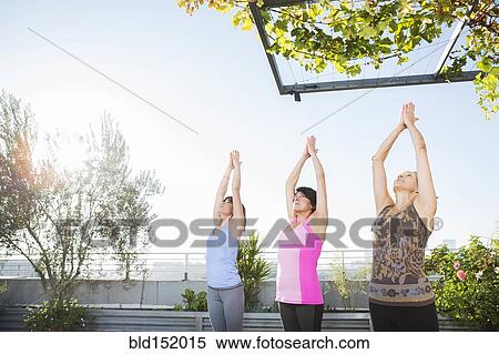 Women practicing yoga together on urban rooftop View Large Photo Image Stock Photography - Women practicing yoga together on urban rooftop. Fotosearch