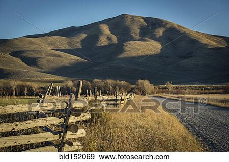 Wooden fence and rural field near mountain View Large Photo Image Stock Photo - Wooden fence and rural field near mountain. Fotosearch