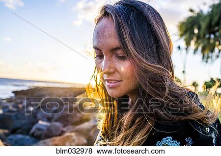 Close up of Caucasian woman on rocky beach View Large Photo Image Stock Photo - Close up of Caucasian woman on rocky beach. Fotosearch
