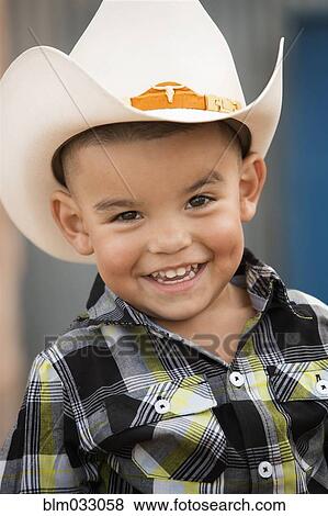 Stock Photo - Hispanic boy wearing cowboy hat. Fotosearch