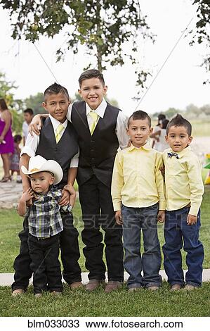 Stock Image - Hispanic boys celebrating quinceanera. Fotosearch