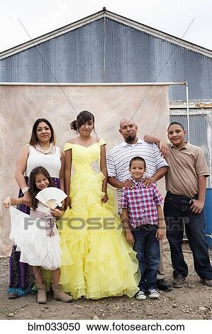 Stock Image - Hispanic family celebrating quinceanera. Fotosearch
