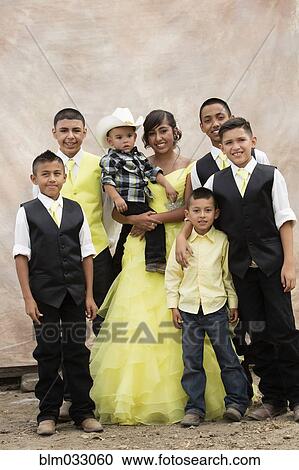 Stock Image - Hispanic family celebrating quinceanera. Fotosearch