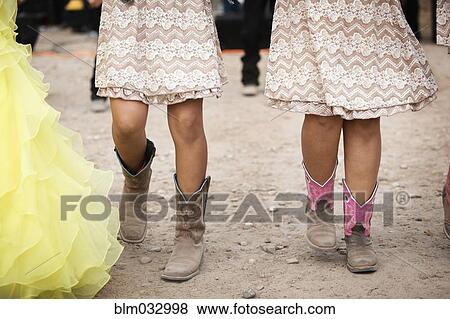 Stock Photo - Hispanic girls wearing cowboy boots and dresses. Fotosearch
