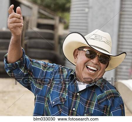 Hispanic man wearing cowboy hat on ranch View Large Photo Image Stock Image - Hispanic man wearing cowboy hat on ranch. Fotosearch