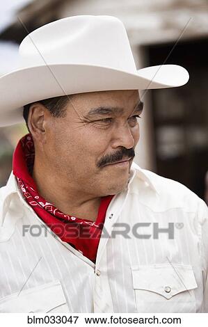 Stock Photo - Hispanic man wearing cowboy hat outdoors. Fotosearch