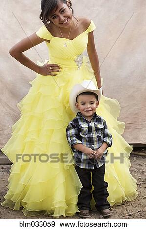 Hispanic sister and little brother celebrating quinceanera View Large Photo Image Stock Photo - Hispanic sister and little brother celebrating quinceanera. Fotosearch