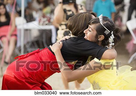 Hispanic woman hugging friend at quinceanera View Large Photo Image Stock Image - Hispanic woman hugging friend at quinceanera. Fotosearch