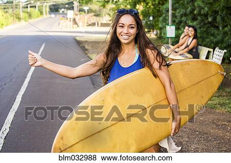 Pacific Islander surfer hitch hiking on rural road View Large Photo Image Stock Photo - Pacific Islander surfer hitch hiking on rural road. Fotosearch
