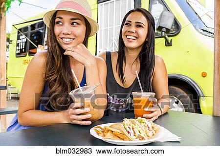 Pacific Islander women eating and drinking near food cart View Large Photo Image Stock Image - Pacific Islander women eating and drinking near food cart. Fotosearch
