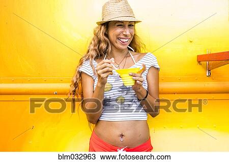 Smiling woman eating shaved ice View Large Photo Image Stock Image - Smiling woman eating shaved ice. Fotosearch