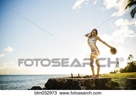 Woman standing on wall near ocean View Large Photo Image Stock Image - Woman standing on wall near ocean. Fotosearch