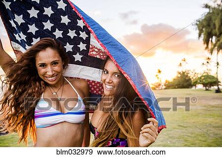 Women standing under American flag quilt at sunset View Large Photo Image Stock Photo - Women standing under American flag quilt at sunset. Fotosearch