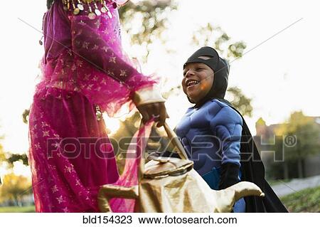 Stock Image - African American children trick-or-treating on Halloween. Fotosearch