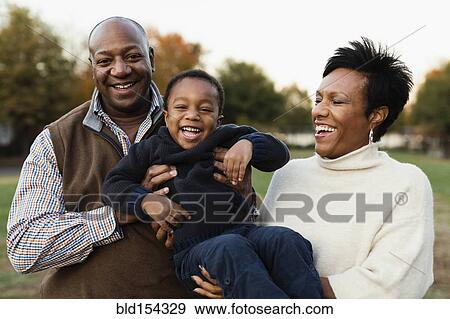 Stock Photo - African American family playing in park. Fotosearch