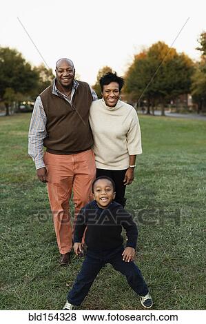 Stock Photo - African American family smiling in park. Fotosearch