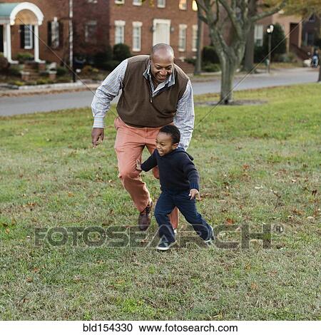 African American father and son playing in park View Large Photo Image Stock Image - African American father and son playing in park. Fotosearch