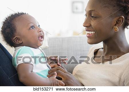 Black mother and son playing on sofa View Large Photo Image Stock Image - Black mother and son playing on sofa. Fotosearch