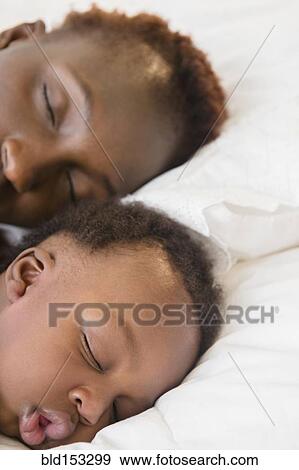 Black mother and son sleeping on bed View Large Photo Image Stock Photo - Black mother and son sleeping on bed. Fotosearch