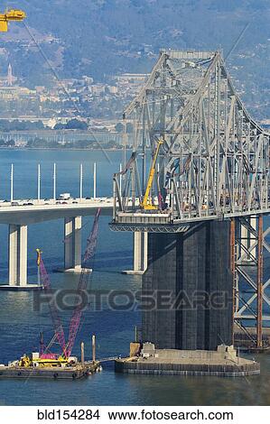 Picture - "Bridge under construction over bay, San Francisco, California, United States". Fotosearch