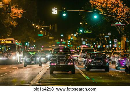 Cars driving in city traffic at night View Large Photo Image Stock Photo - Cars driving in city traffic at night. Fotosearch