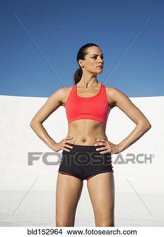 Caucasian athlete standing with hands on hips View Large Photo Image Picture - Caucasian athlete standing with hands on hips. Fotosearch