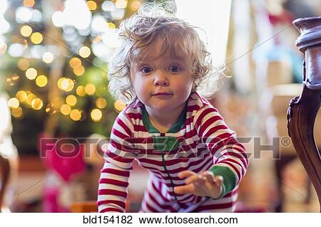 Caucasian baby boy crawling near Christmas tree View Large Photo Image Stock Image - Caucasian baby boy crawling near Christmas tree. Fotosearch