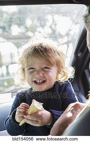 Caucasian baby boy eating ice cream in car View Large Photo Image Stock Photograph - Caucasian baby boy eating ice cream in car. Fotosearch