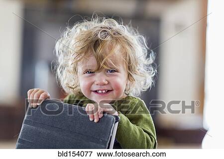 Caucasian baby boy holding digital tablet View Large Photo Image Stock Photo - Caucasian baby boy holding digital tablet. Fotosearch