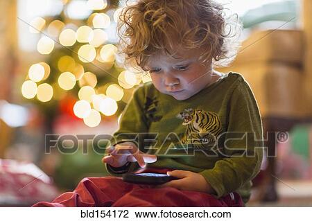 Caucasian baby boy playing with cell phone View Large Photo Image Stock Image - Caucasian baby boy playing with cell phone. Fotosearch