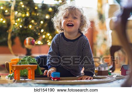 Caucasian baby boy playing with toys near Christmas tree View Large Photo Image Stock Image - Caucasian baby boy playing with toys near Christmas tree. Fotosearch