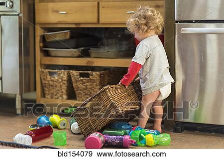 Stock Photo - Caucasian baby boy playing with toys and basket. Fotosearch