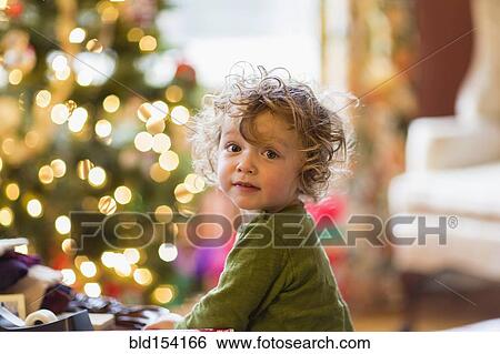 Caucasian baby boy sitting near Christmas tree View Large Photo Image Stock Photograph - Caucasian baby boy sitting near Christmas tree. Fotosearch