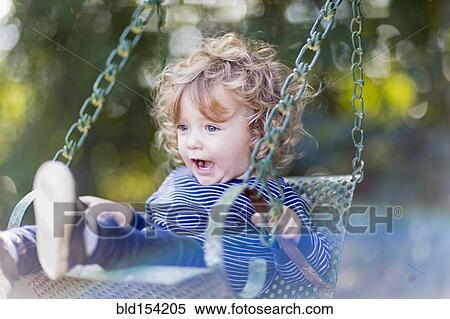 Caucasian baby boy sitting on swing View Large Photo Image Stock Photography - Caucasian baby boy sitting on swing. Fotosearch