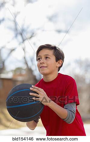 Caucasian boy playing basketball outdoors View Large Photo Image Stock Photograph - Caucasian boy playing basketball outdoors. Fotosearch