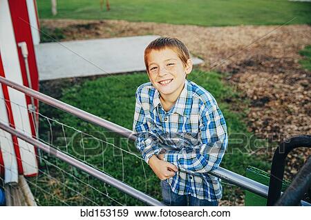 Stock Photo - Caucasian boy smiling on farm. Fotosearch
