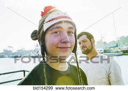 Stock Photo - Caucasian boy wearing knitted cap in harbor. Fotosearch
