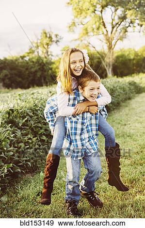 Stock Photo - Caucasian children playing in crop field on farm. Fotosearch