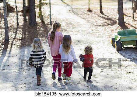 Stock Photography - Caucasian children walking in yard. Fotosearch