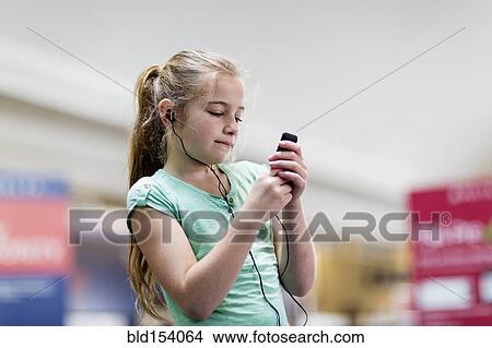 Caucasian girl listening to mp3 player View Large Photo Image Picture - Caucasian girl listening to mp3 player. Fotosearch