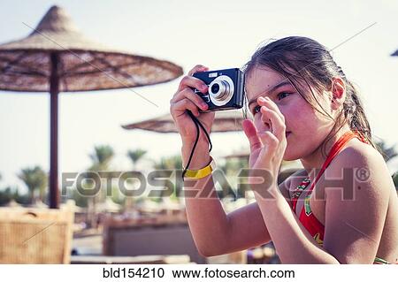 Caucasian girl photographing outdoors View Large Photo Image Stock Image - Caucasian girl photographing outdoors. Fotosearch