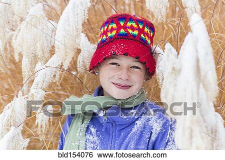 Stock Photograph - Caucasian girl smiling in snow. Fotosearch