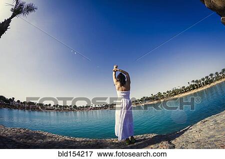 Caucasian girl standing at lake View Large Photo Image Stock Photo - Caucasian girl standing at lake. Fotosearch