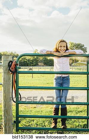 Caucasian girl standing on fence on ranch View Large Photo Image Stock Photo - Caucasian girl standing on fence on ranch. Fotosearch